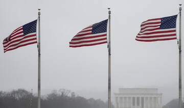 The Lincoln Memorial is seen in the distance as U.S. flags fly at the base of the Washington Monument in Washington. (AP)