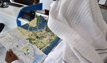 A Saudi customer looks at a touristic leaflet brochure about Turkey at a travel agency in Riyadh on July 2, 2019. (AFP)