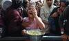 A young displayed Palestinian girl reacts as she receives a portion of food, at a shelter where families have been living. A young displayed Palestinian girl reacts as she receives a portion of food, at a shelter where families have been living.