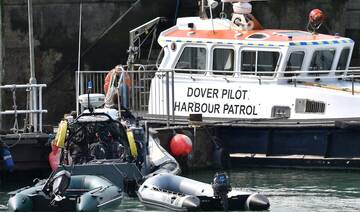 Picture shows dinghy used by group of migrants to illegally cross the English Channel from France, as they are brought to shore.