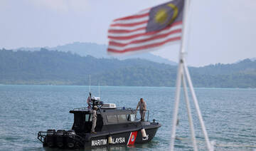 Malaysian Maritime Enforcement Agency officers search for victims during a search and rescue operation.