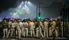 Security personnel gather at the blast site after an explosion near the Red Fort in the old quarters of Delhi.