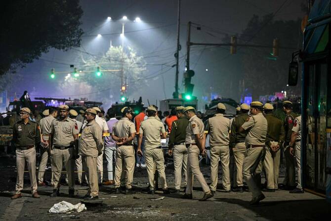 Security personnel gather at the blast site after an explosion near the Red Fort in the old quarters of Delhi.