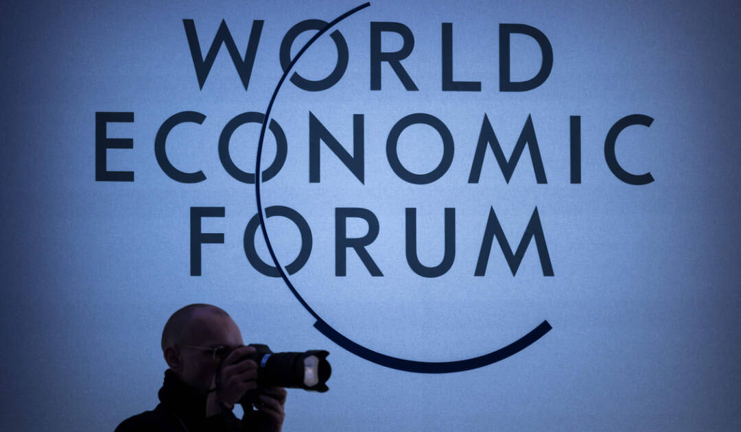 A press photographer operates during a session of the World Economic Forum (WEF) meeting in Davos on January 18, 2024. (AFP)