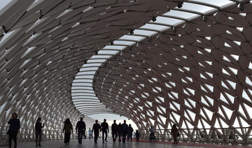 People walk on a bridge over the Ishim river in Nur-Sultan on June 8, 2019. (AFP)