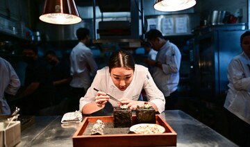 A chef prepares a dish in the kitchen before it is served. (File/AFP)