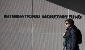 A woman walks past the IMF ahead of the IMF/World Bank Spring Meetings in Washington, on April 17, 2025. (AFP)